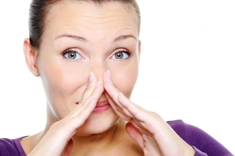 como fica a respiração após a rinoplastia? moça demonstrando ação de assoar o nariz